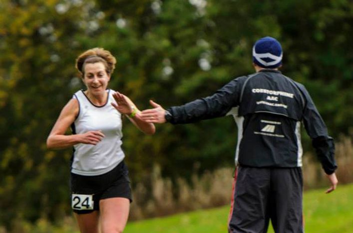 A coach directs a runner